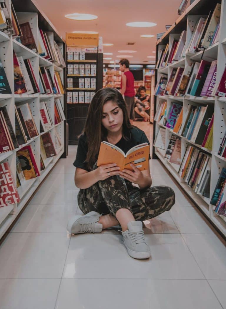 woman sitting on floor while reading best ap us history books